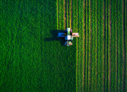 tractor mowing field - aerial view