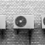 Row of air conditioning units on wall