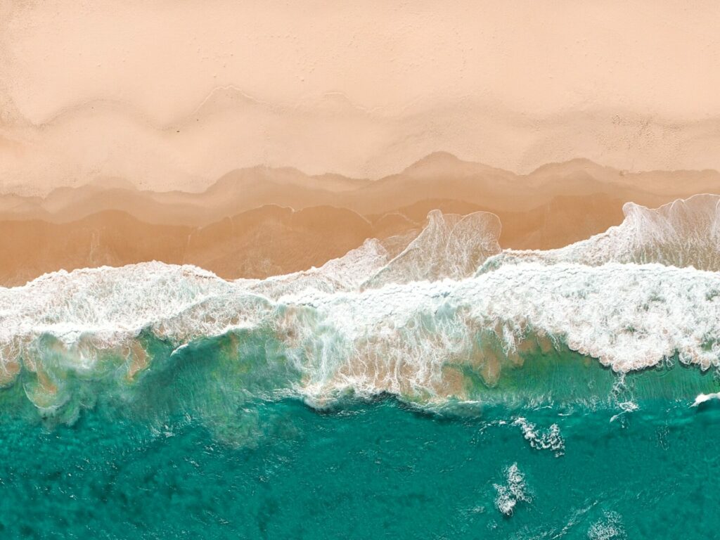 Waves gently lapping at sandy beach