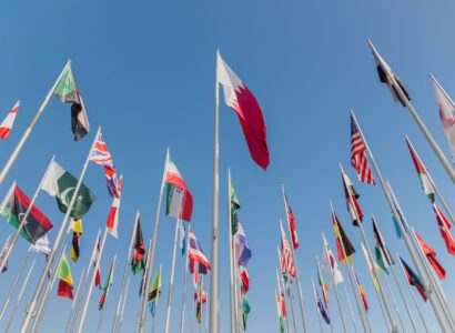 Low angle shot of Flag Plaza against a cloudless blue sky