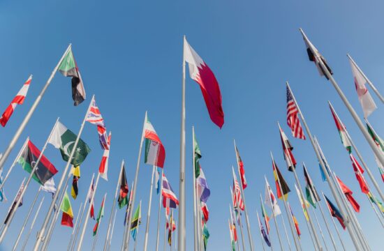 Low angle shot of Flag Plaza against a cloudless blue sky