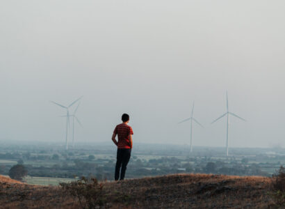 Man standing in front of windmills in Gujarat, India